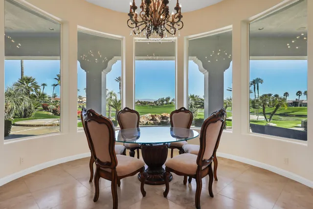 a view of a dining room with furniture and a potted plant