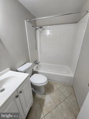 a bathroom with a double vanity sink toilet and shower