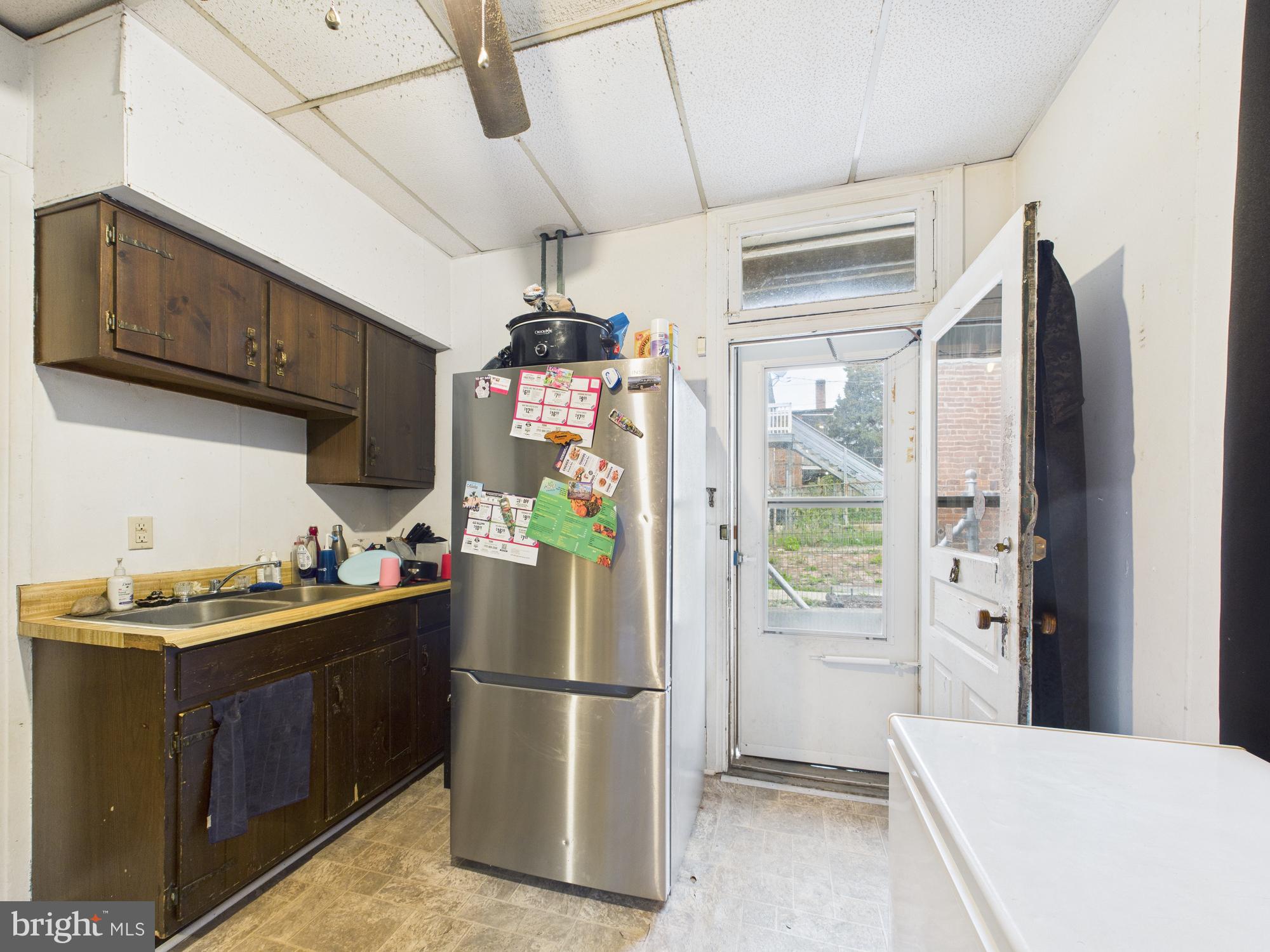 828 West Princess Street York, PA 17401 - Photo 5 of 32 a kitchen with a refrigerator a stove top oven a sink and cabinets