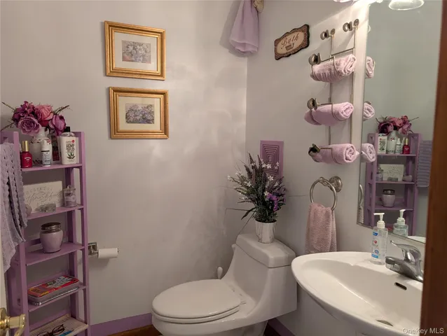 a white toilet sitting next to a bathroom sink and vanity