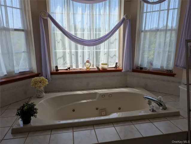 a bathroom with a bathtub and a window