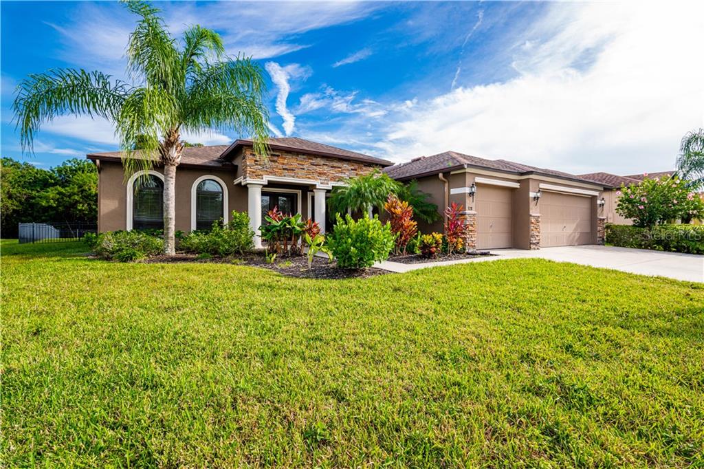 328 Hope Bay Loop Apollo Beach, FL 33572 - Photo 1 of 1 a front view of a house with garden