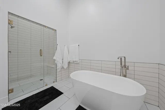 a bathroom with a bathtub and shower