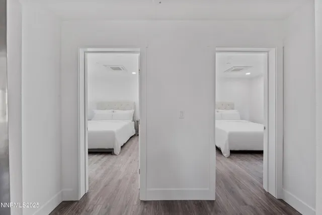 a bedroom with bed and wooden floor