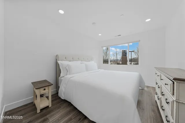 a bedroom with a large bed and a large window