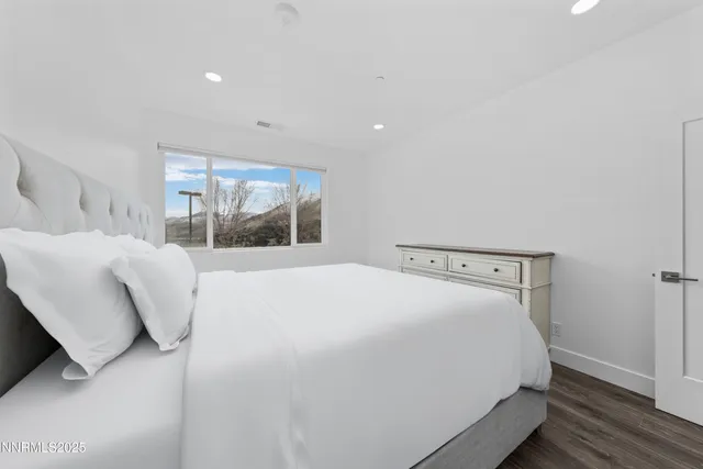 a bedroom with a large bed and a large window