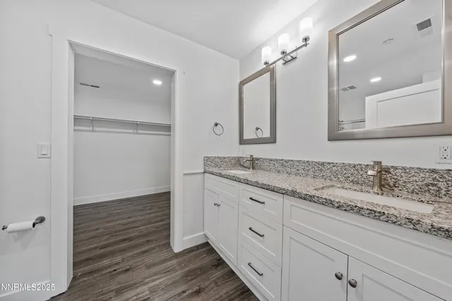 a bedroom with a bed a window and wooden floor