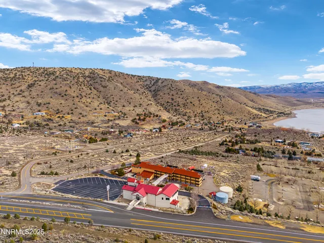 a view of a terrace with lawn chairs