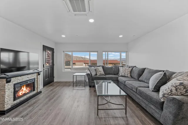 a living room with furniture and a fireplace