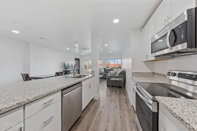 a kitchen with a sink stove and cabinets