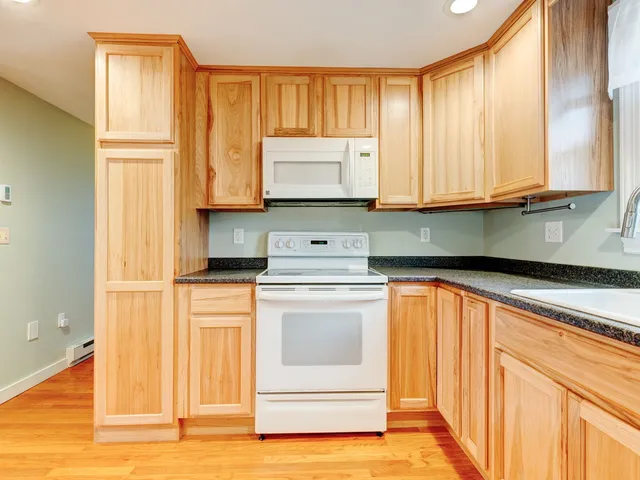 a kitchen with stainless steel appliances granite countertop a refrigerator sink and cabinets