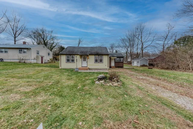 a front view of a house with a yard