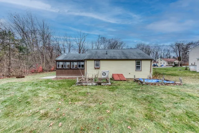 a view of a house with a backyard