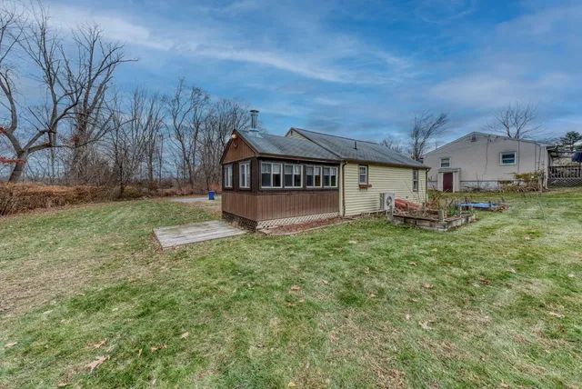 a view of a house with a yard