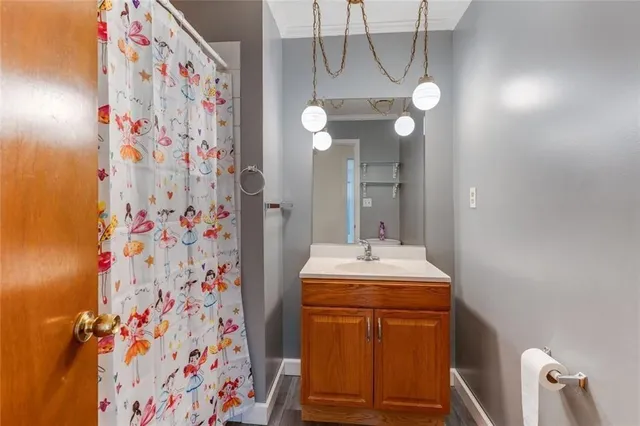 a bathroom with a sink vanity and toilet