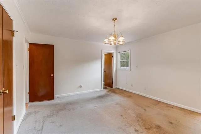 a view of an empty room with a chandelier
