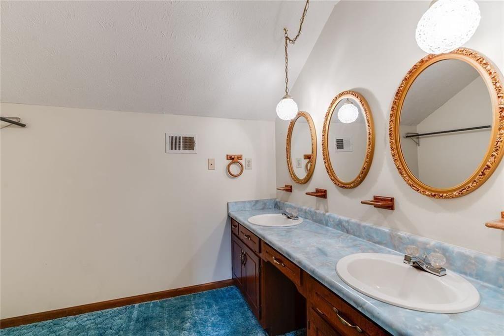 7306 Mt Vernon Road Lithia Springs, GA 30122 - Photo 27 of 48 a bathroom with a granite countertop sink and a mirror