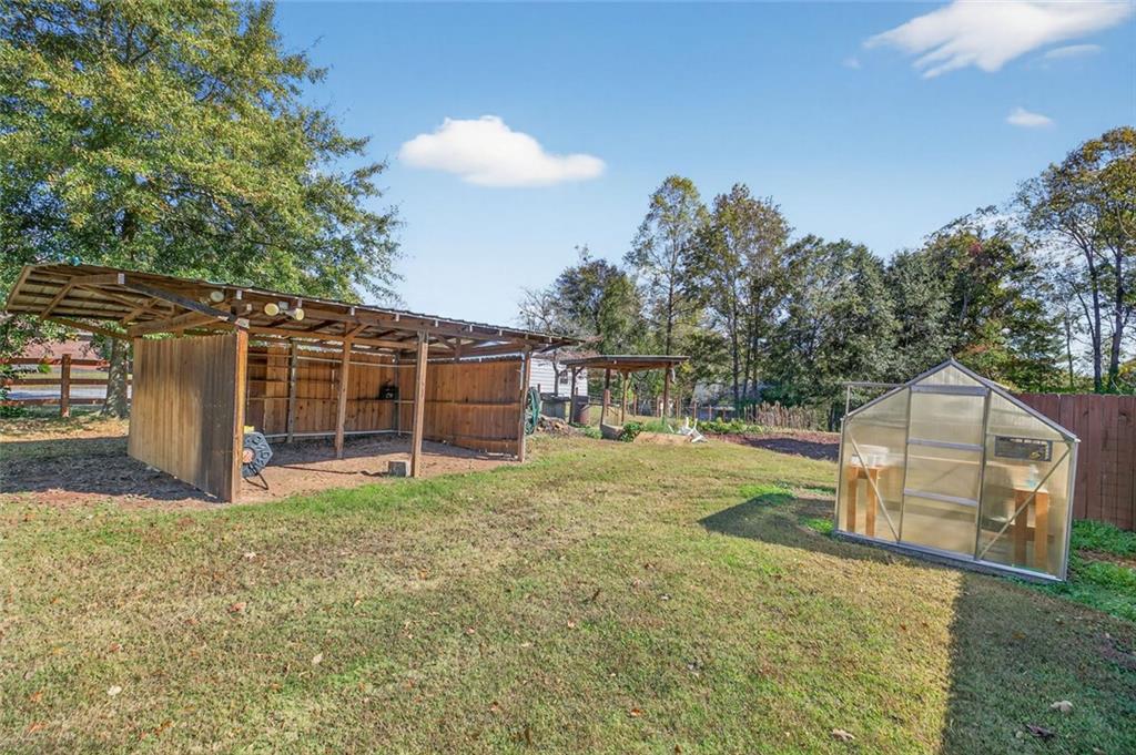7306 Mt Vernon Road Lithia Springs, GA 30122 - Photo 38 of 48 a view of a house with backyard and a tree
