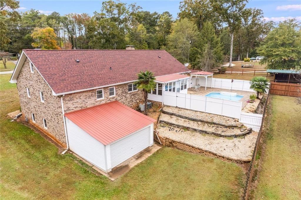7306 Mt Vernon Road Lithia Springs, GA 30122 - Photo 39 of 48 a view of a big house with a big yard and large trees