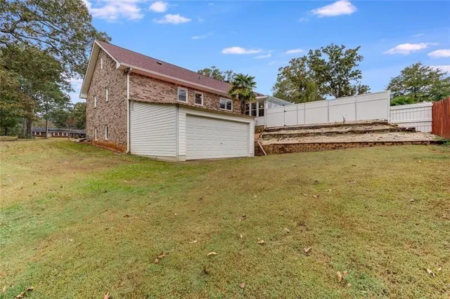 a view of a house with a yard and garage