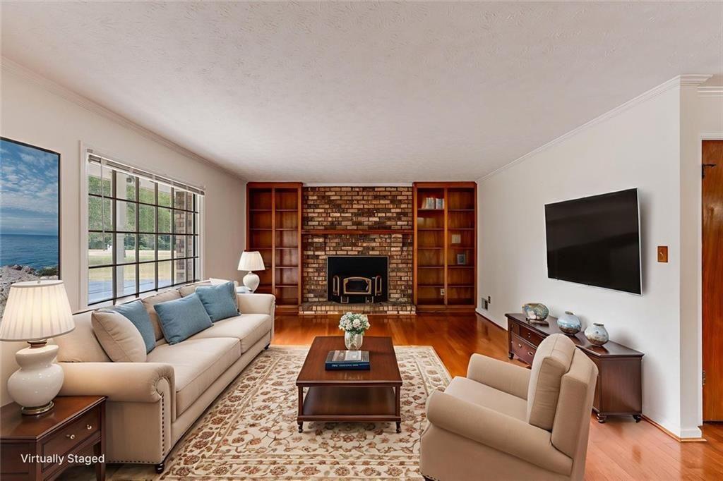 7306 Mt Vernon Road Lithia Springs, GA 30122 - Photo 6 of 48 a living room with furniture a flat screen tv and a fireplace