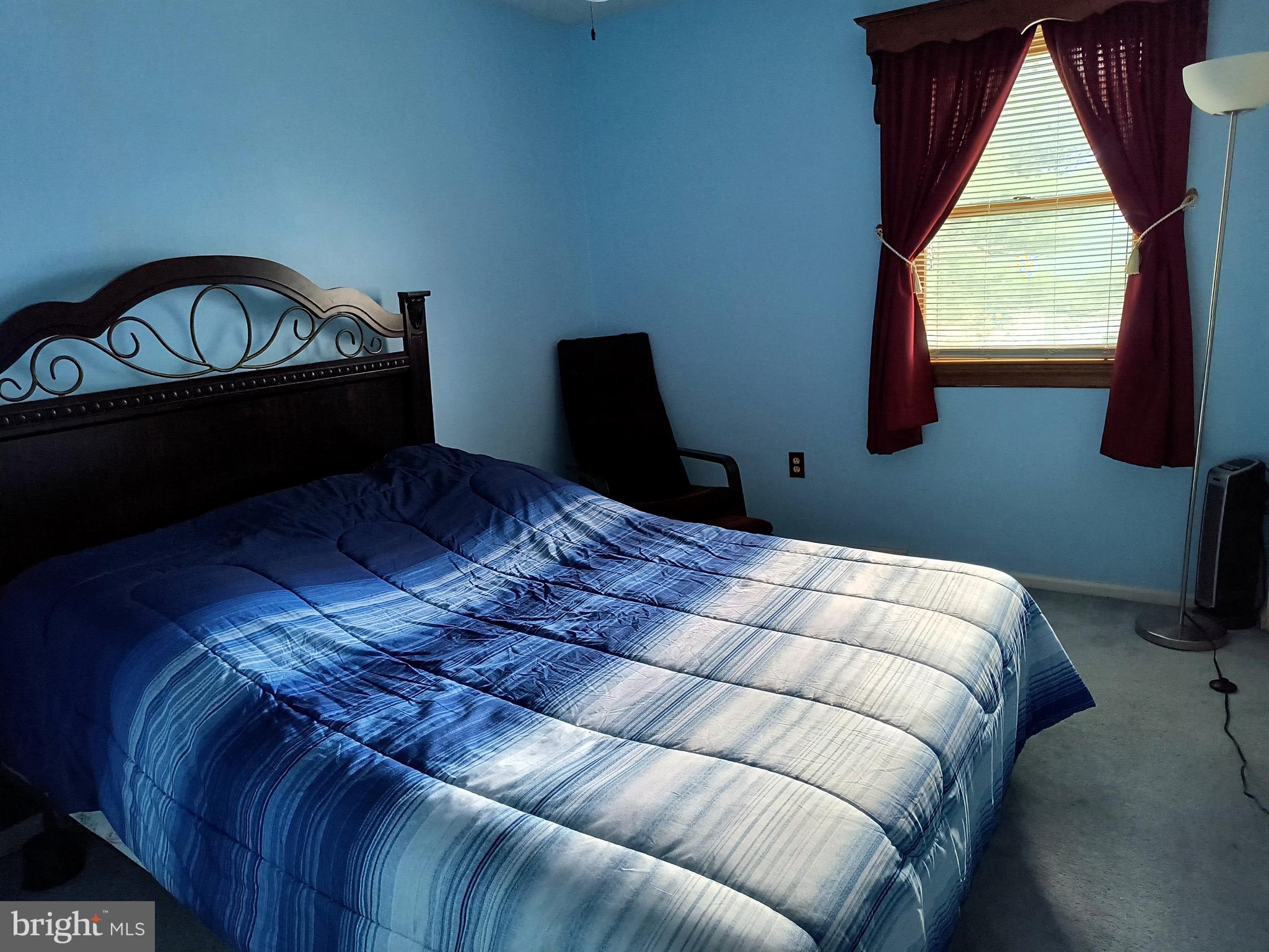 102 Providence Drive Bear, DE 19701 - Photo 13 of 21 a bed sitting in a bedroom next to a window