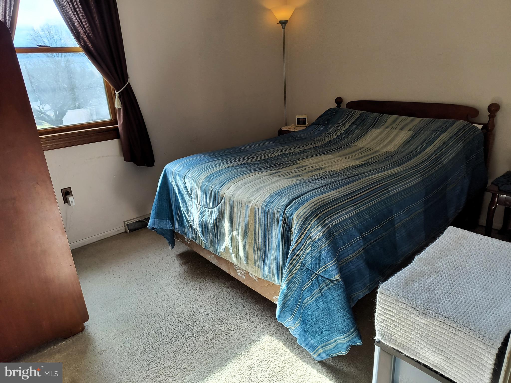 102 Providence Drive Bear, DE 19701 - Photo 14 of 21 a bed sitting in a bedroom next to a window