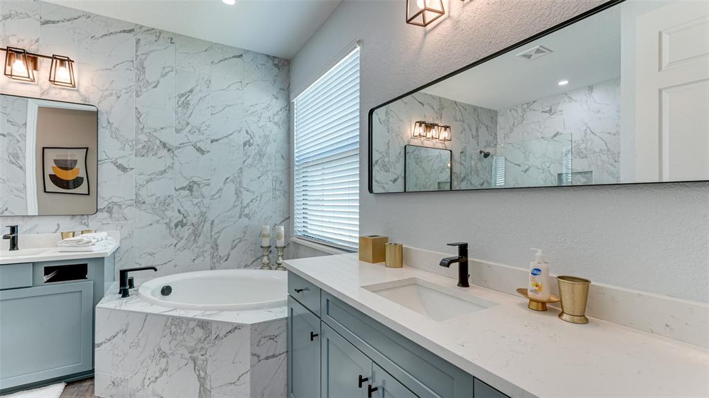 5725 Cheech Glen Lakewood Ranch, FL 34211 - Photo 12 of 63 a bathroom with a sink and a mirror