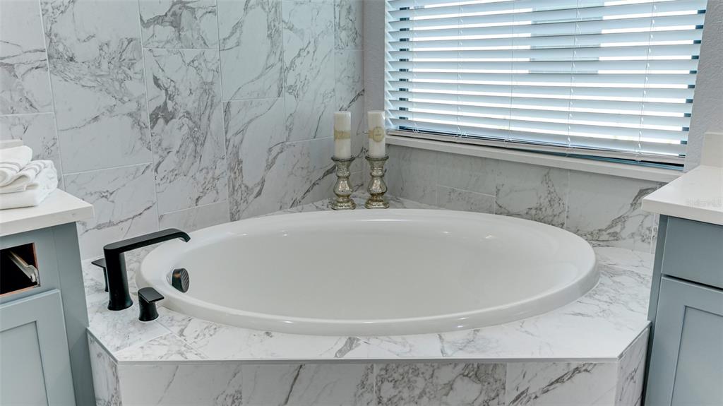 5725 Cheech Glen Lakewood Ranch, FL 34211 - Photo 14 of 63 a bathroom with a bathtub and a window