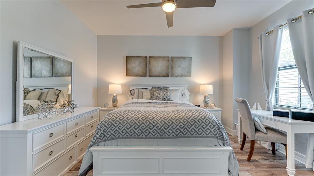 5725 Cheech Glen Lakewood Ranch, FL 34211 - Photo 17 of 63 a bedroom with a bed and a chandelier