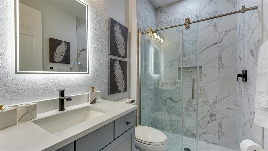 5725 Cheech Glen Lakewood Ranch, FL 34211 - Photo 18 of 63 a bathroom with a sink a toilet and shower