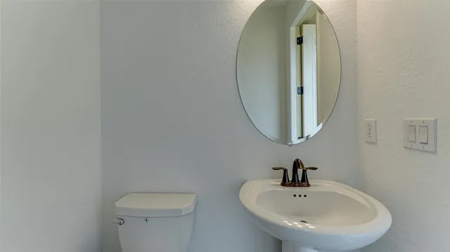 a living room with furniture a clock and a view of kitchen