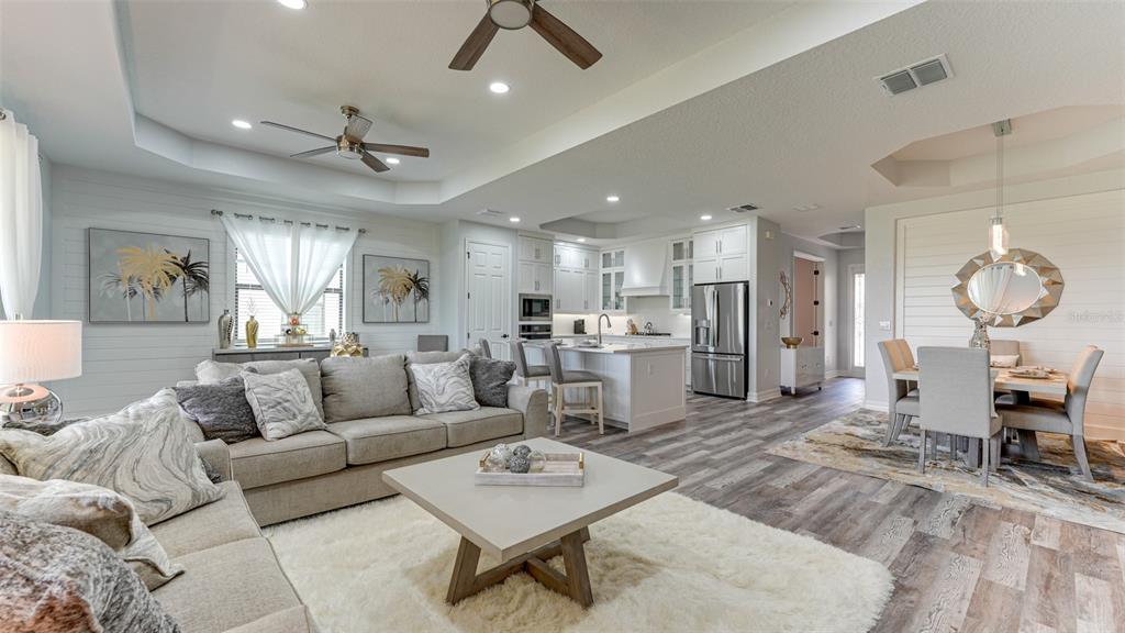 5725 Cheech Glen Lakewood Ranch, FL 34211 - Photo 24 of 63 a living room with furniture a clock and a view of kitchen