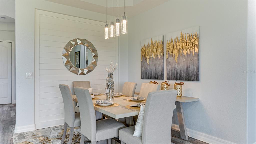 5725 Cheech Glen Lakewood Ranch, FL 34211 - Photo 25 of 63 a view of a dining room with furniture and chandelier