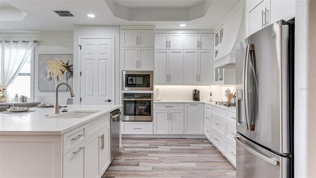 5725 Cheech Glen Lakewood Ranch, FL 34211 - Photo 4 of 63 a kitchen with white cabinets and refrigerator
