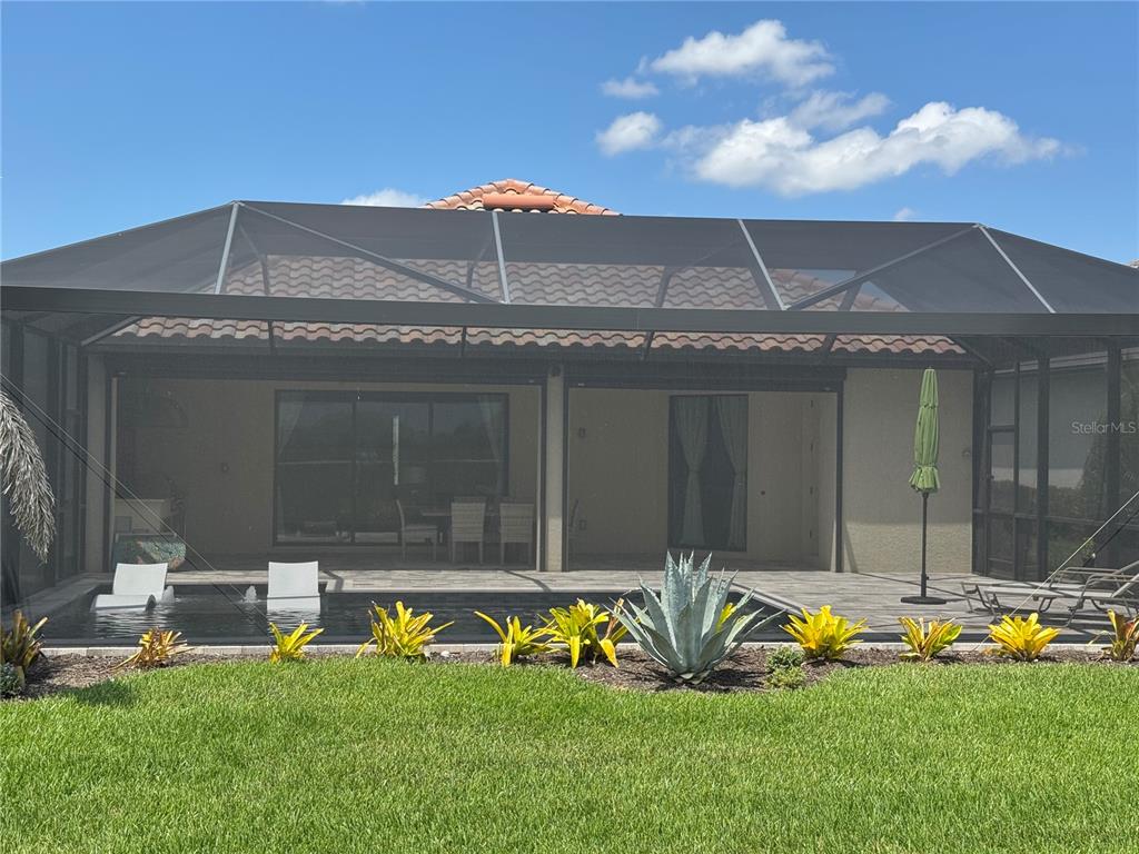 5725 Cheech Glen Lakewood Ranch, FL 34211 - Photo 62 of 63 a view of a house with a backyard and a patio