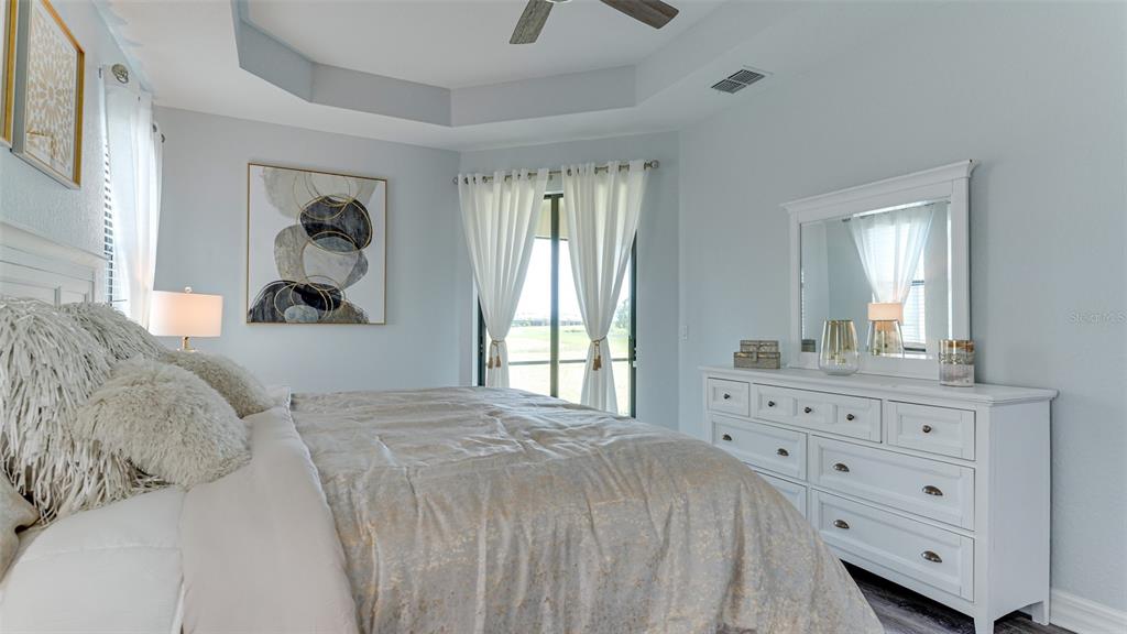 5725 Cheech Glen Lakewood Ranch, FL 34211 - Photo 8 of 63 a bedroom with a bed and a dresser
