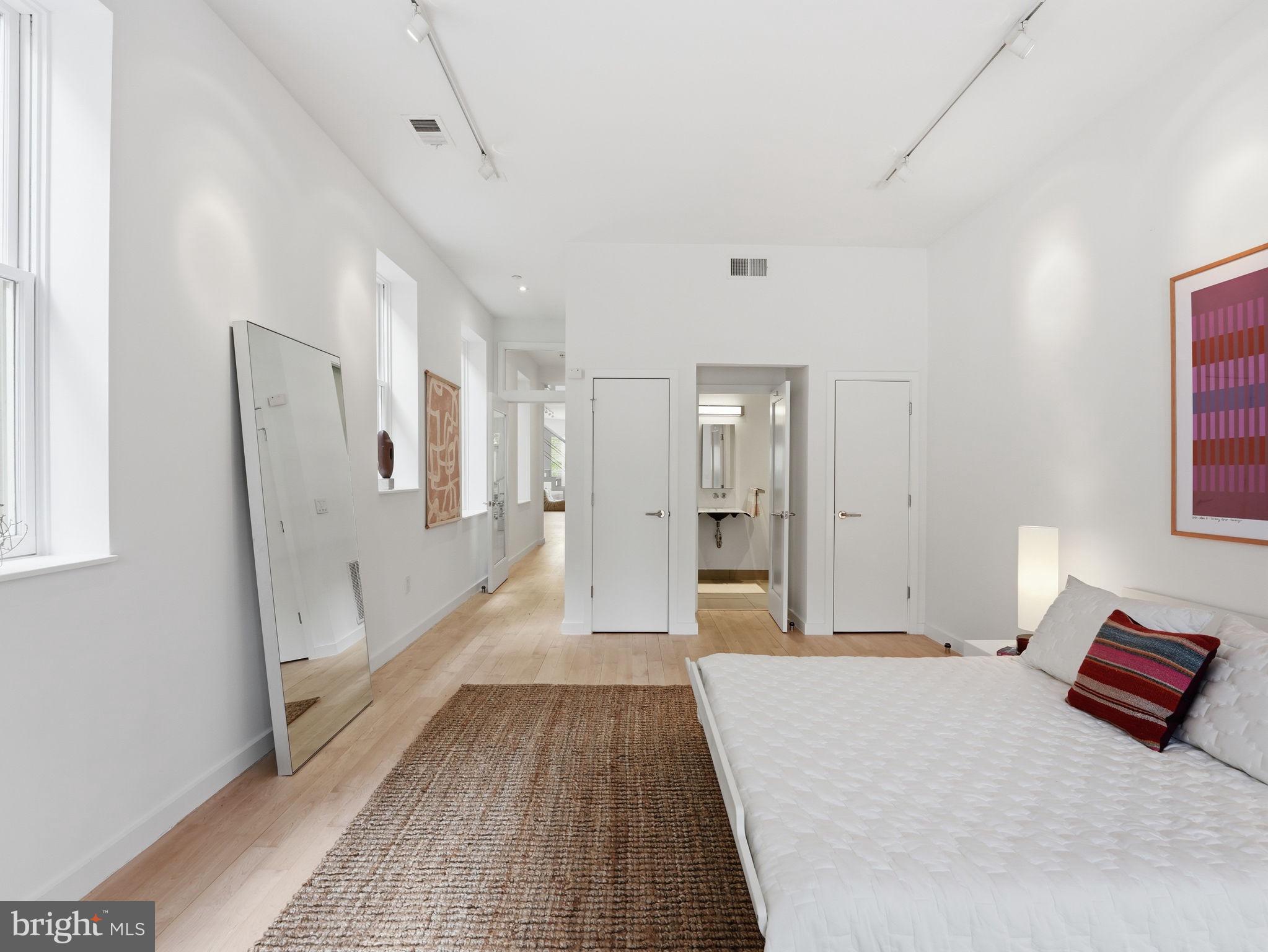 1845 Calvert Street Northwest Washington, DC 20009 - Photo 43 of 48 a bedroom with a bed and a rug