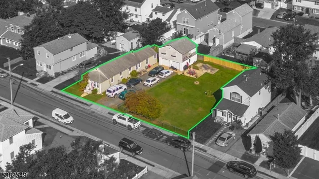 an aerial view of a house with a garden and swimming pool