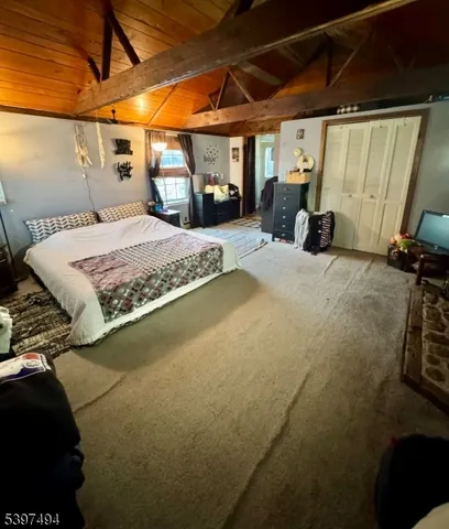 a bedroom with a bed and a mirror