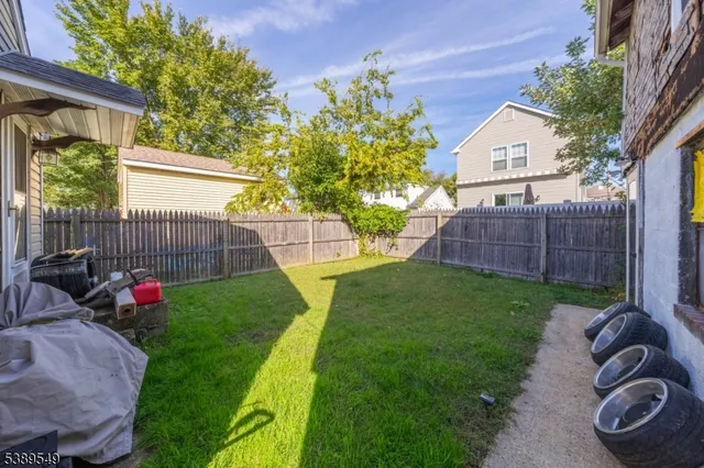 a kitchen with a sink a stove and wooden floor