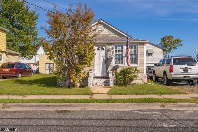 a view of a house with a yard and pathway
