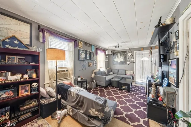 a living room with furniture and a floor to ceiling window