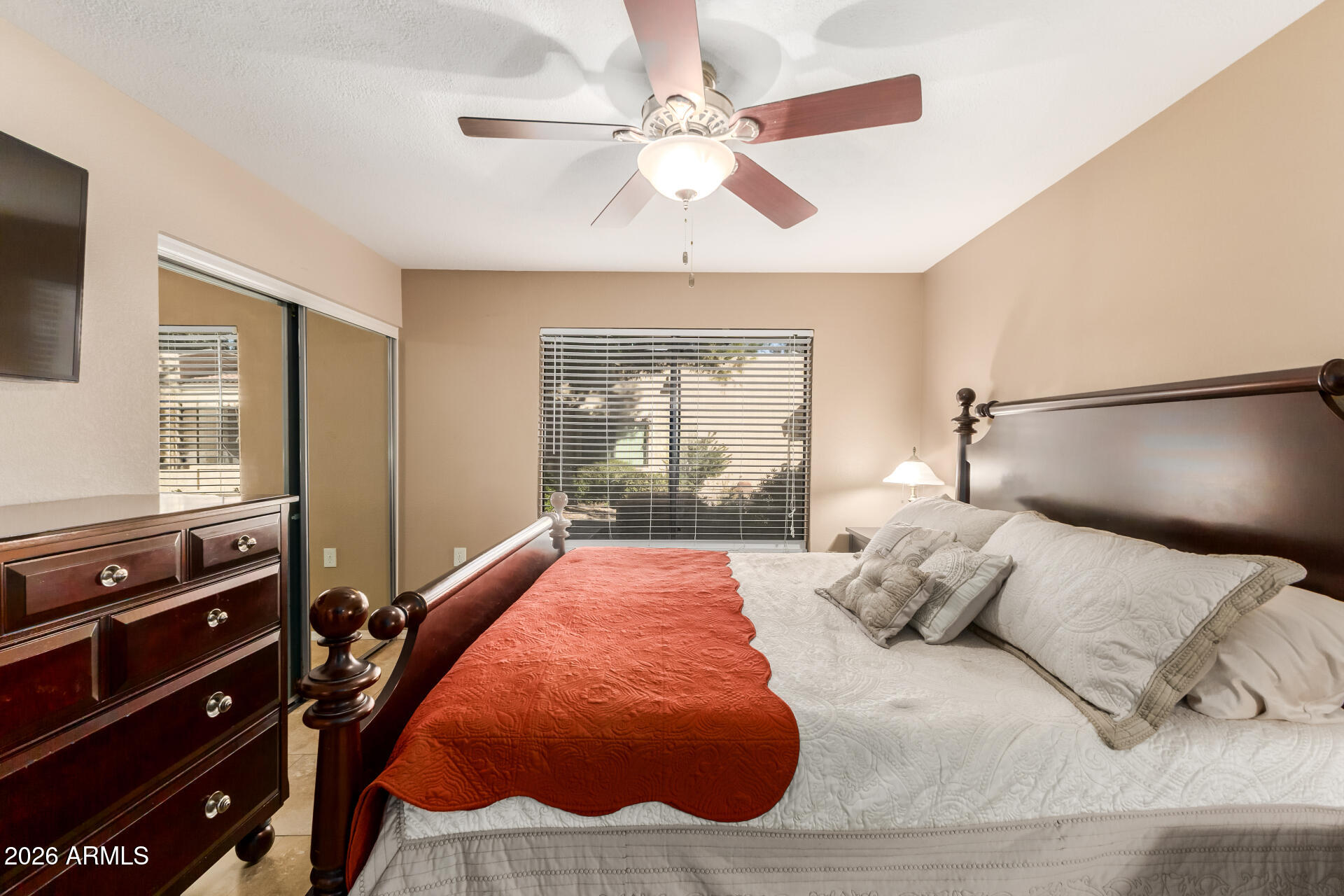 14300 West Bell Road, Unit 153 Surprise, AZ 85374 - Photo 11 of 19 a bedroom with a bed and wooden floor