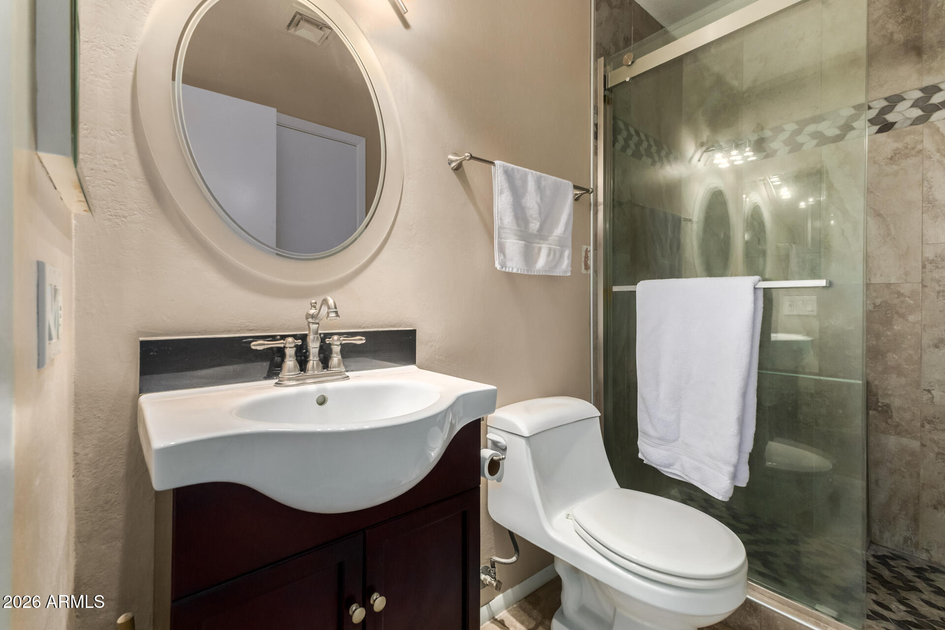 14300 West Bell Road, Unit 153 Surprise, AZ 85374 - Photo 13 of 19 a bathroom with a toilet sink and mirror