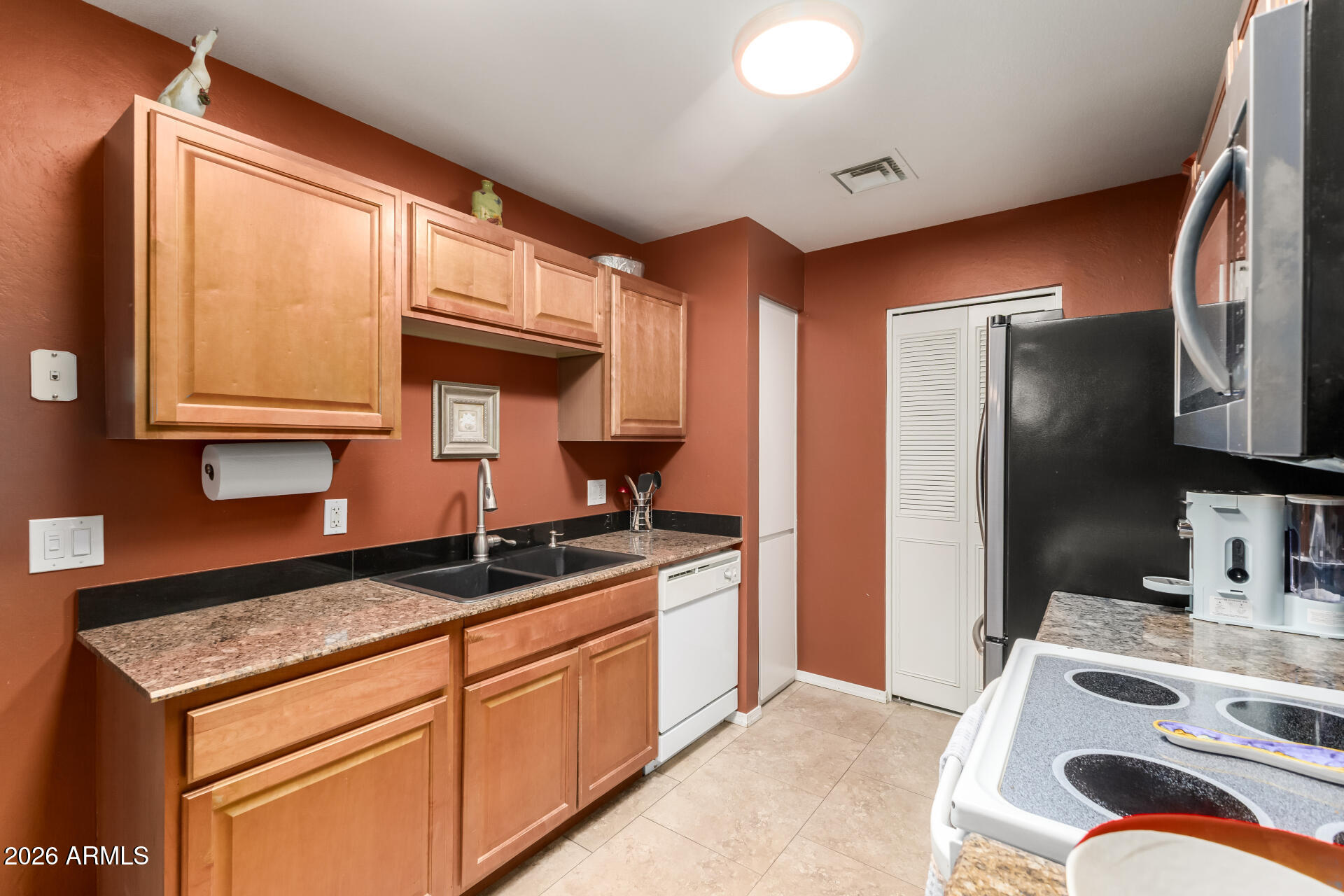 14300 West Bell Road, Unit 153 Surprise, AZ 85374 - Photo 8 of 19 a kitchen with stainless steel appliances granite countertop a sink stove and refrigerator