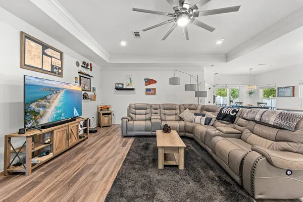 a living room with furniture and wooden floor