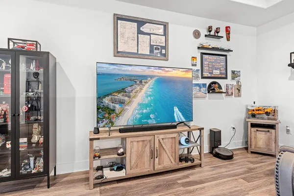 a living room with lots of furniture and kitchen view