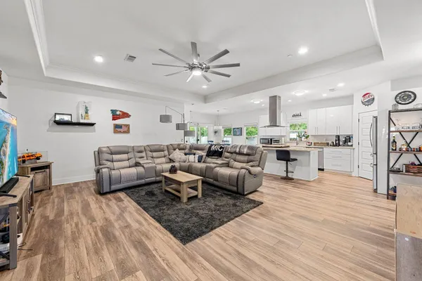 a kitchen with stainless steel appliances kitchen island a large counter space a sink and a stove
