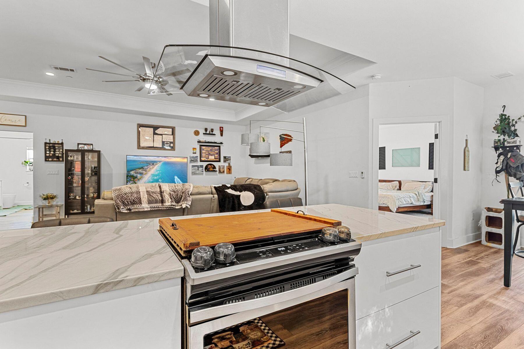 736 Comanche Drive Fort Walton Beach, FL 32547 - Photo 19 of 49 a kitchen with stainless steel appliances granite countertop a stove oven and a white cabinets